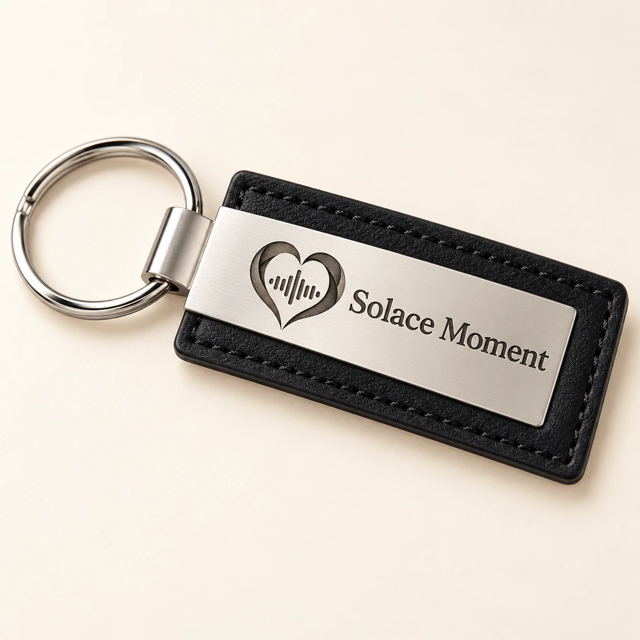 Signature Legacy Keychain with black leather, brushed silver-tone metal and engraved Solace Moment heart and name